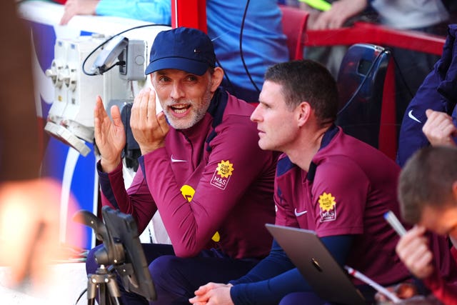 Thomas Tuchel gestures to his coaching staff on the England bench