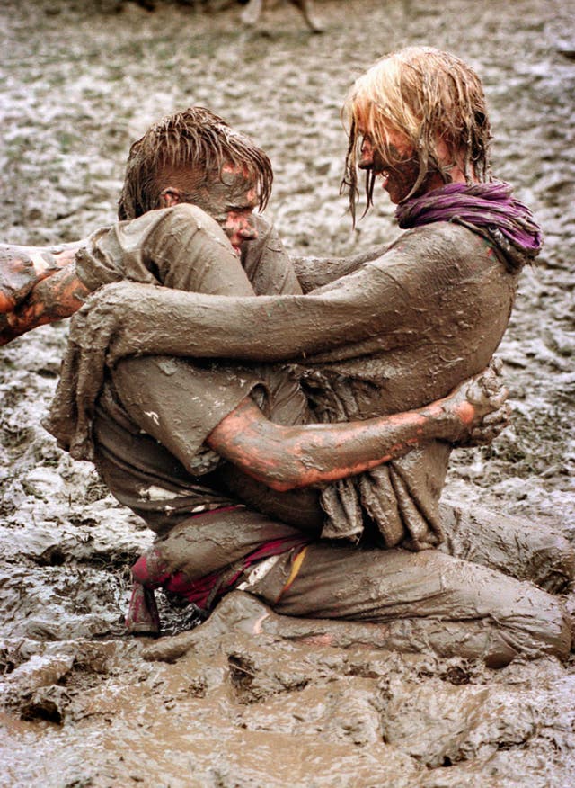 Music fans enjoy the mud pools at the 1997 Glastonbury festival (Martin Bennett/PA)
