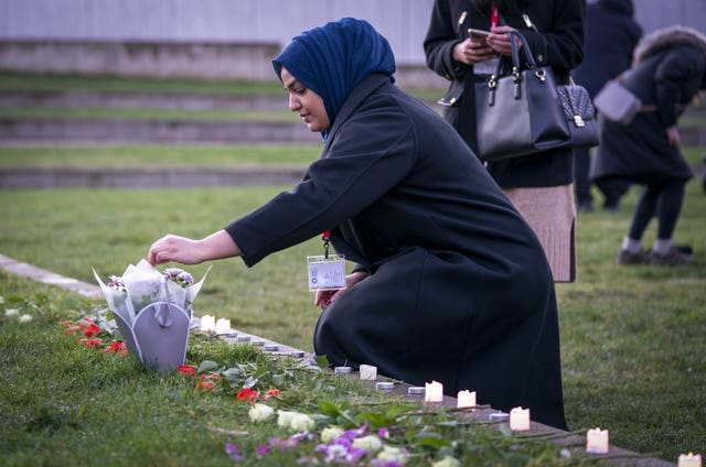 Farah Siddiq lays flowers during the vigil 