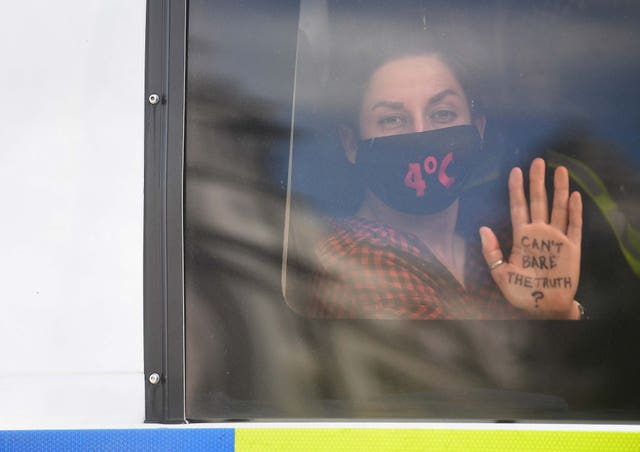 An Extinction Rebellion protester in a police van outside the Houses of Parliament 