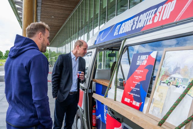 England captain Harry Kane stands with the Prince of Wales as he gets a coffee during a visit to St George’s Park