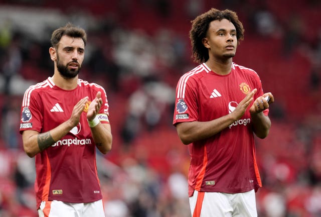 Manchester United’s Joshua Zirkzee, (right) and teammate Bruno Fernandes applaud the fans at the end of a game at Old Trafford