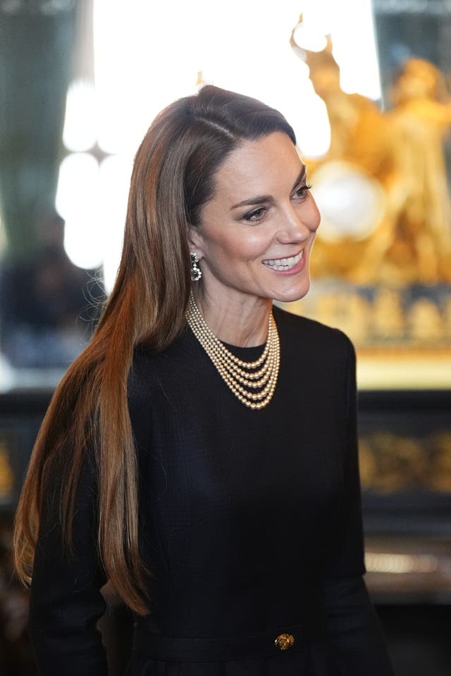 Kate wearing her hair sleek and straight as she view a collection of German artefacts in the castle 