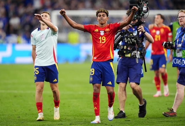 Spain’s Lamine Yamal, centre, and Fermin Lopez celebrate after beating France