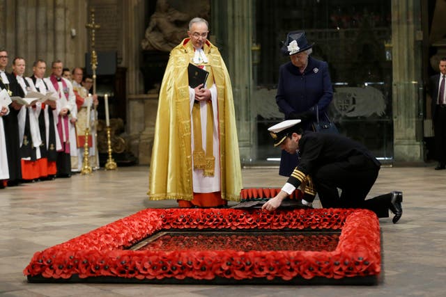 Queen Elizabeth II watches as a wreath is laid at the Grave of the Unknown Warrior at a service marking the 70th anniversary of VE Day in 2015