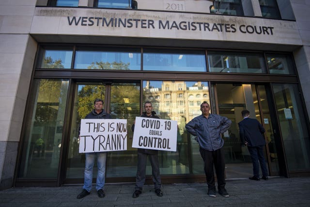 Anti-lockdown demonstrators outside Westminster Magistrates’ Court (Victoria Jones/PA)
