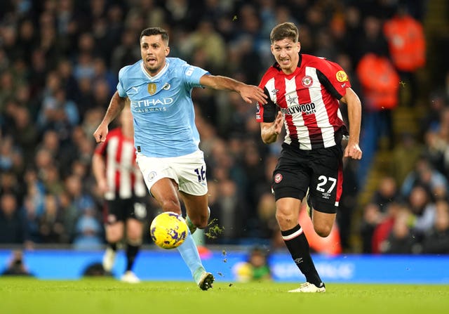 Manchester City’s Rodri (left) battles for the ball with Brentford’s Vitaly Janelt