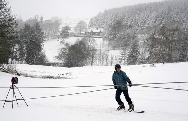 A snowboarder takes to a hill in Northumberland