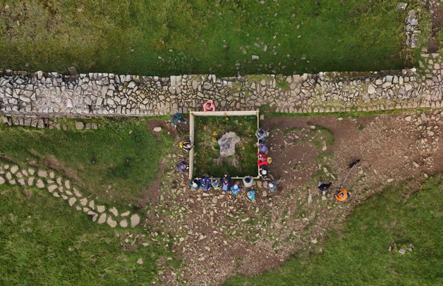 People gather around the stump of the Sycamore Gap tree in Northumberland