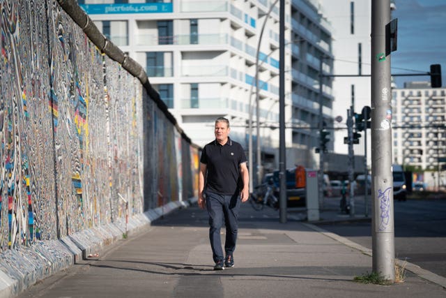Labour leader Sir Keir Starmer walks past a section of the Berlin Wall known as the East Side Gallery in Berlin