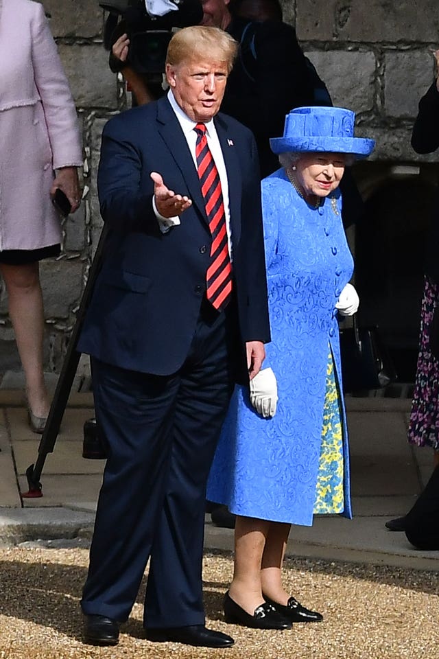 Donald Trump walking with the Queen