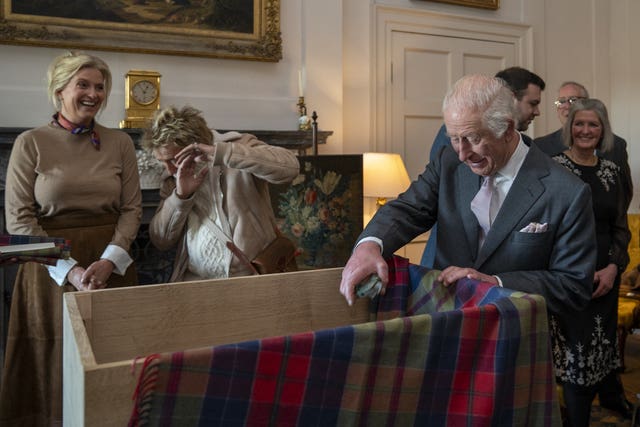 Sir Rod Stewart hiding his face with his hands, while the King holds a pair of secateurs