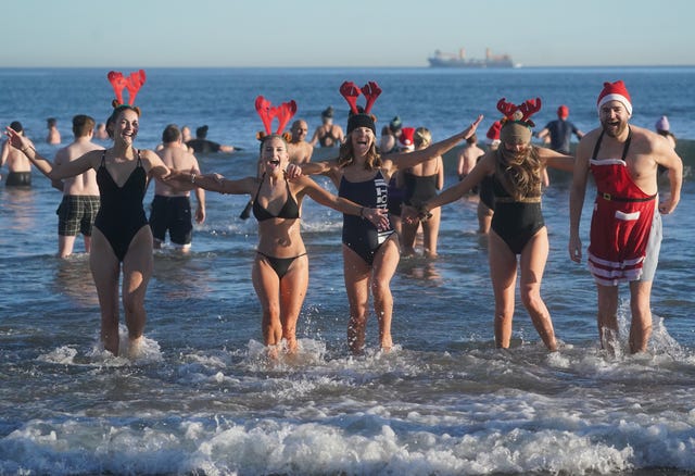 A group of swimmers with reindeer headbands 