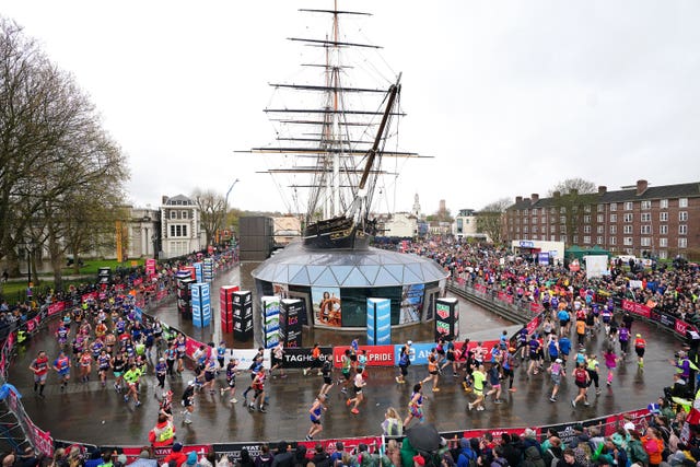 Runners pass Cutty Sark during the 2023 TCS London Marathon 