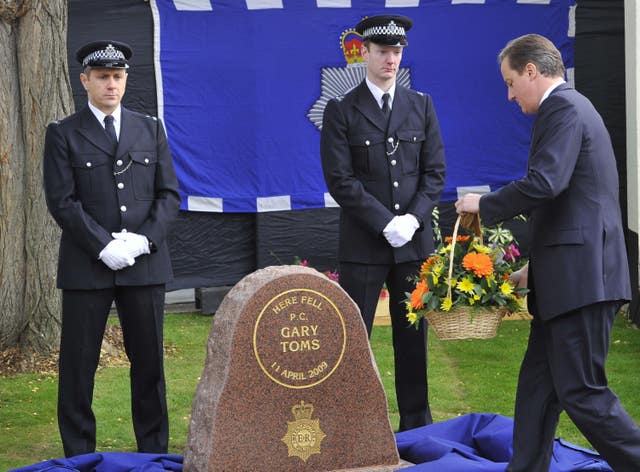David Cameron lays a wreath during a memorial ceremony for Gary Toms