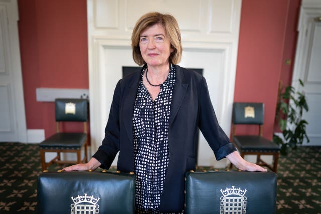 Sue Gray’s standing in between two chairs bearing the portcullis symbol of Parliament