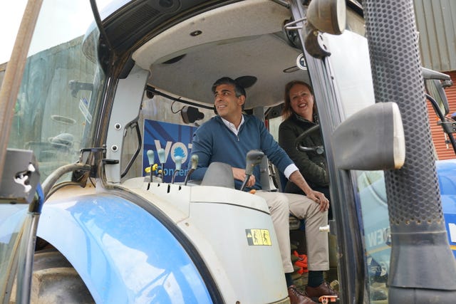 Prime Minister Rishi Sunak and Attorney General and parliamentary candidate for Banbury, Victoria Prentis, sitting in a tractor during a visit to Wykham Park Farm in Banbury, Oxfordshire