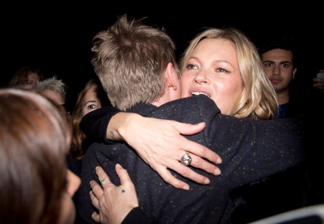 Bailey hugs Kate Moss after his last Burberry show (Isabel Infantes/PA)