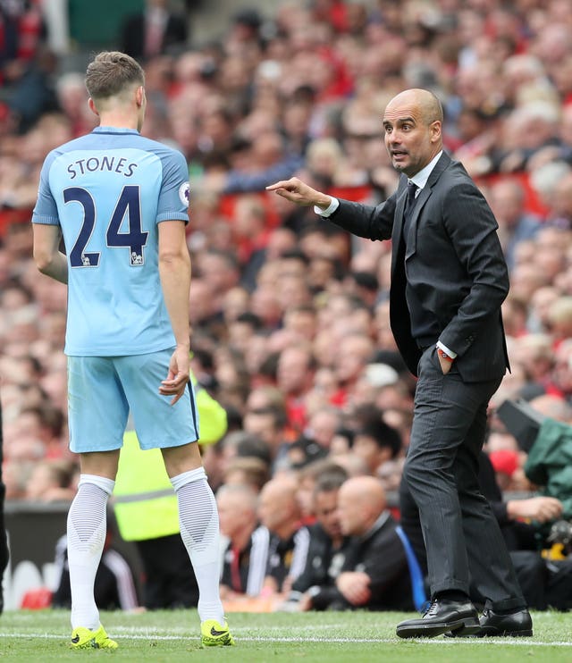 Guardiola (right) retains high hopes for Stones (Martin Rickett/PA)