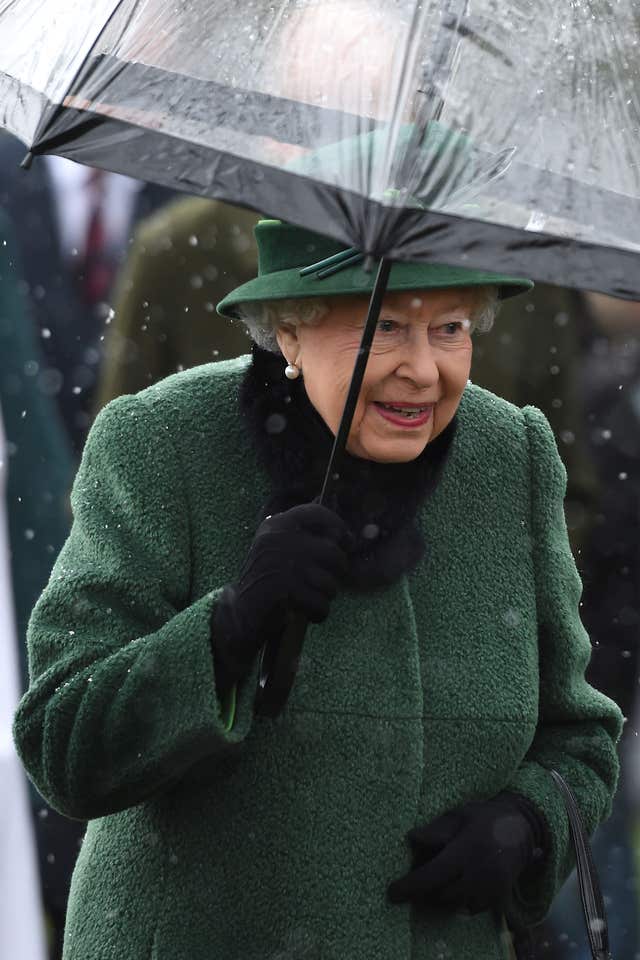 The monarch was all smiles despite the downpour