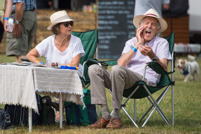 A man applies sun cream during the Thames Traditional Boat Festival