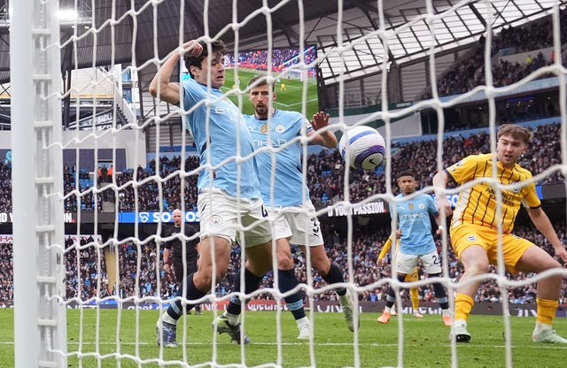 View from behind the net as Manchester City’s Abdukodir Khusanov, left, scores an own goal for Brighton's equaliser