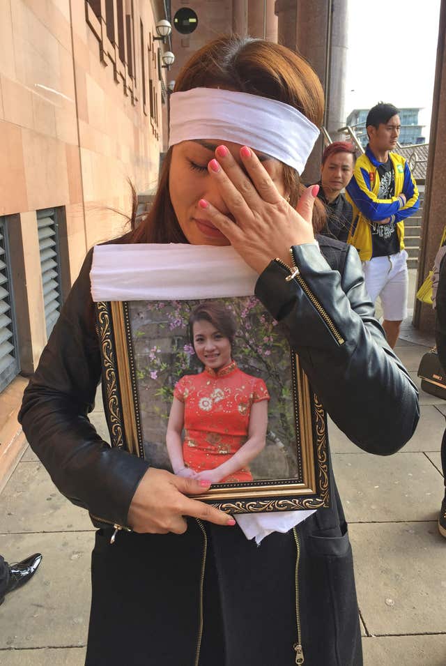 A mourner outside Newcastle Crown Court carries a photograph of Quyen Ngoc Nguyen (Tom Wilkinson/PA)