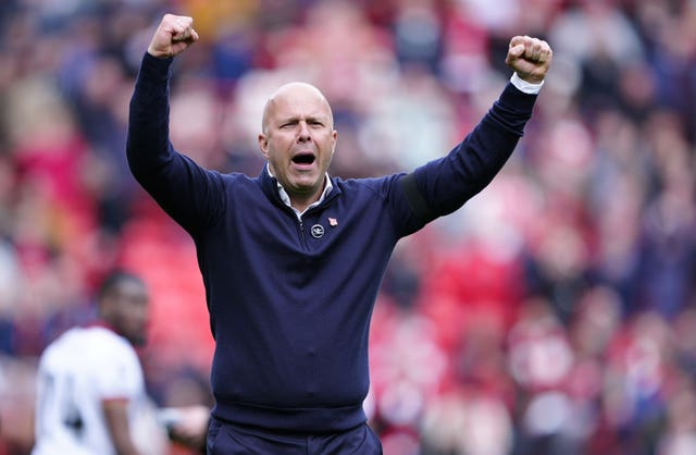 Liverpool head coach Arne Slot raises both arms in celebration