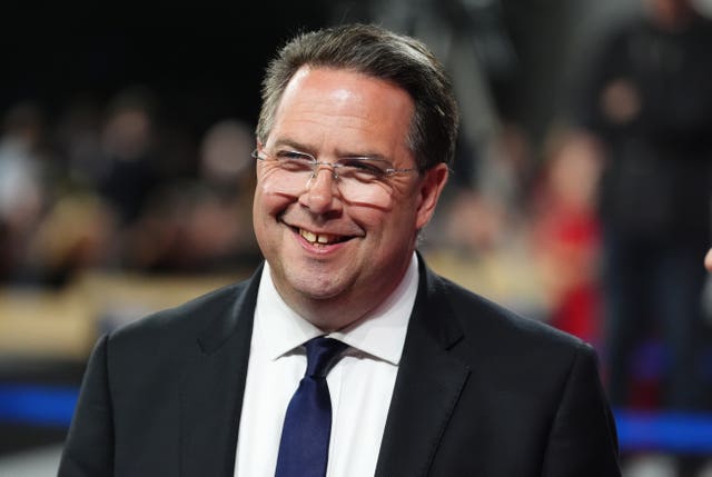 Head and shoulders photo of Craig Hoy smiling, wearing suit jacket, shirt and tie