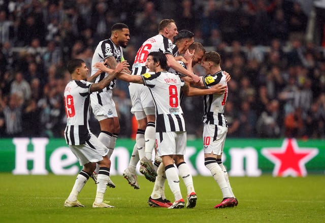 Newcastle’s Dan Burn celebrates scoring his side’s second goal in a 4-1 Champions League win over Paris St Germain