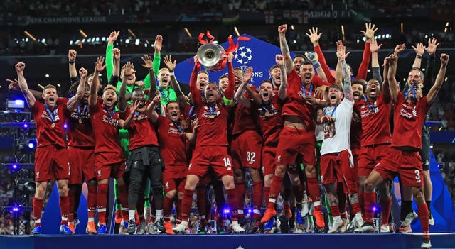 Liverpool’s Jordan Henderson lifts the Champions League trophy with his team-mates