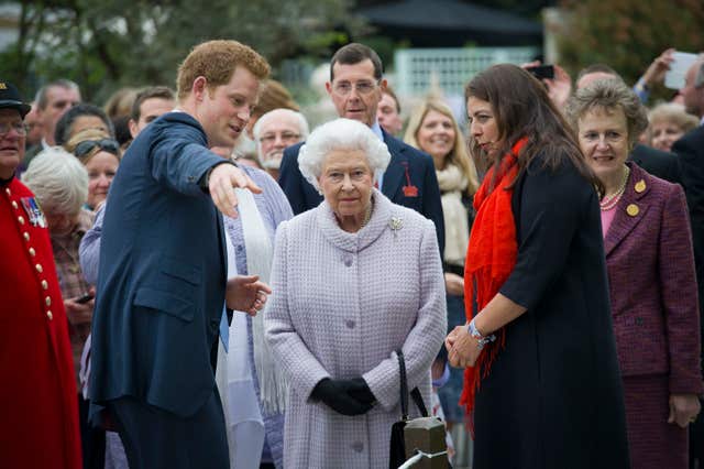 Harry gives his grandmother th Queen a tour of his Sentebale garden at the Chelsea Flower Show in 2013. Geoff Pugh/PA Wire