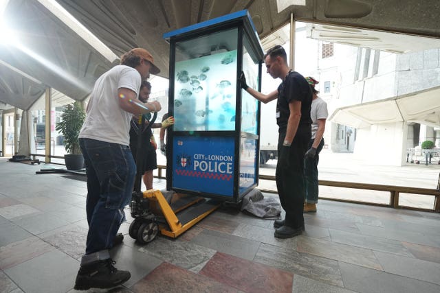 Banksy's painting of piranha fish on a City of London Police sentry box