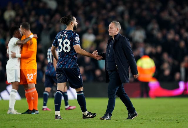 Steve Cooper, right, comforts defender Felipe after losing to Leeds