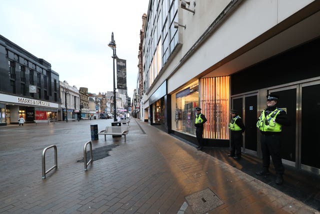 Police community support officers patrol along Briggate in the city centre of Leeds, West Yorkshire