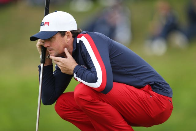 Keegan Bradley bends over to study a putt in the Ryder Cup