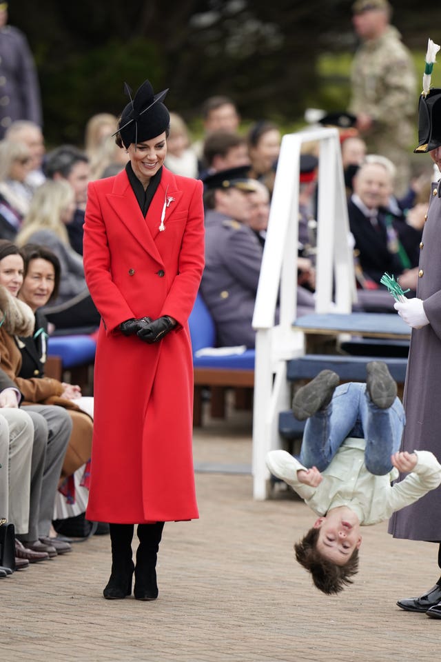 Kate watches a young boy perform a back-flip at the St David’s Day parade 