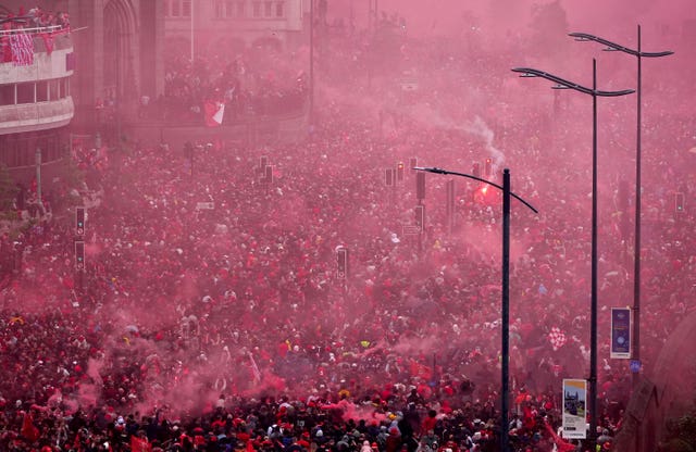 Crowds of people let off smoke cannisters at Liverpool's parade