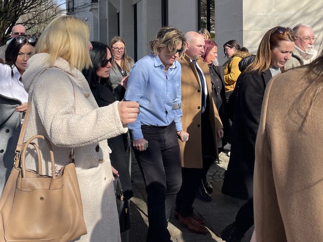 Nerys Lloyd (centre, on crutches) leaving Swansea Crown Court