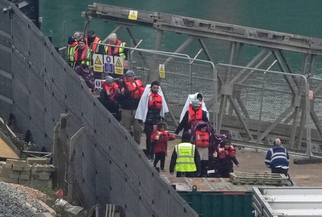 A group of people thought to be migrants, including young children, are brought in to Dover on Friday