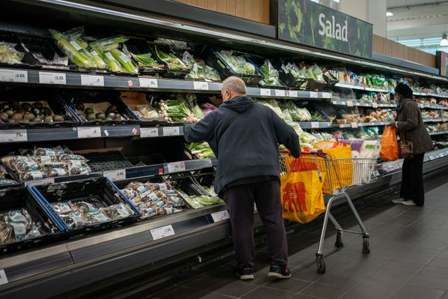 Shoppers in the fruit and vegetables section of a branch of Sainsbury’s 