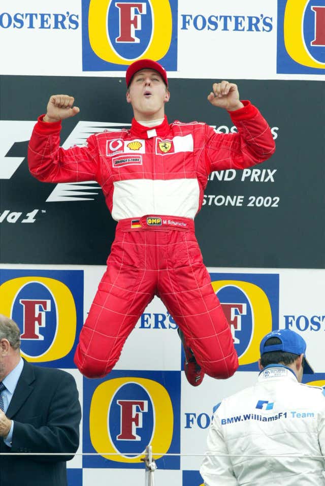 Schumacher's trademark leap marked another win at Silverstone en route to the drivers' championship in 2002.