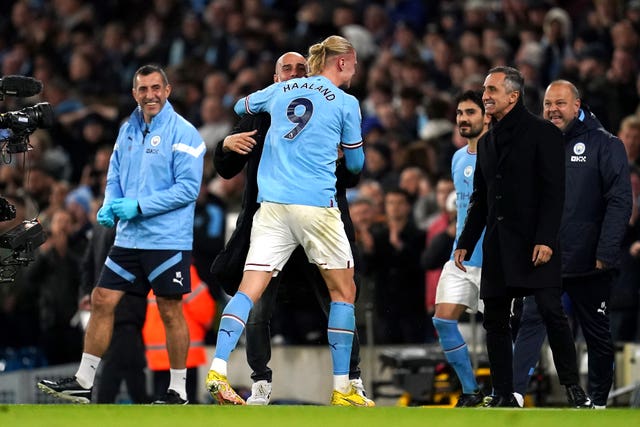 Erling Haaland and manager Pep Guardiola celebrate the winning goal