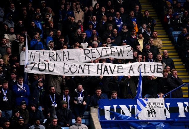 Leicester fans hold up a protest banner during the Premier League match against Arsenal which says 'internal review, you haven't a club'.