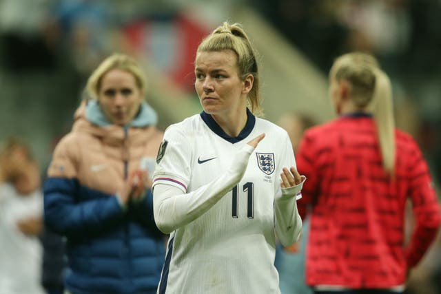 England forward Lauren Hemp, wearing a white number 11 shirt, claps and looks to her left