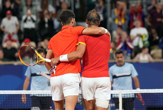 Rafael Nadal, right, and Carlos Alcaraz celebrate victory arm in arm