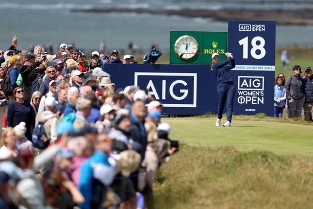 Spectators watch as England’s Lottie Woad tees off on the 18th on day two of the 2025 AIG Women’s Open at Royal Porthcawl