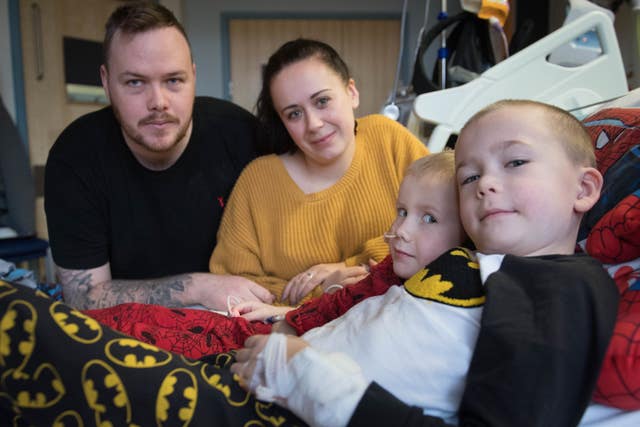 Fiona and Lee Cripps with their sons, four-year-old Ollie (centre) and Finley, six, from Sittingbourne, Kent, at the Royal Marsden hospital in Surrey, after Finley donated his stem cells to his brother (Stefan Rousseau/PA)