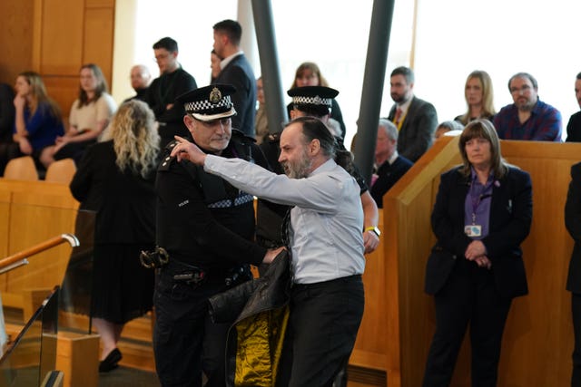 Protester in the public gallery at Holyrood