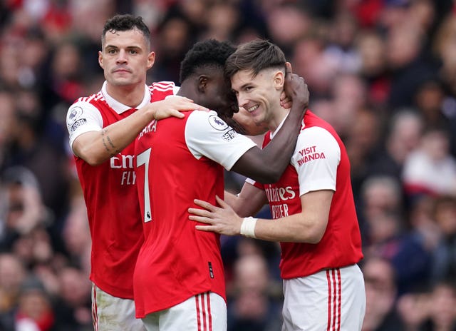 Arsenal’s Bukayo Saka celebrates with Granit Xhaka and Kieran Tierney